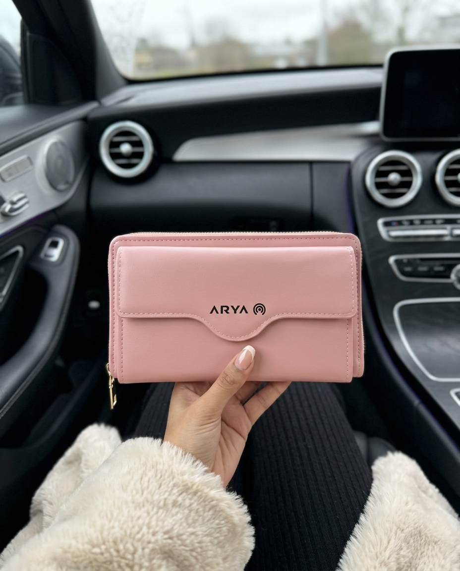 Woman holding an Arya blush pink SJ-24 wallet purse in a luxury car interior